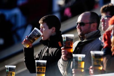 Rugby fans enjoy a beer